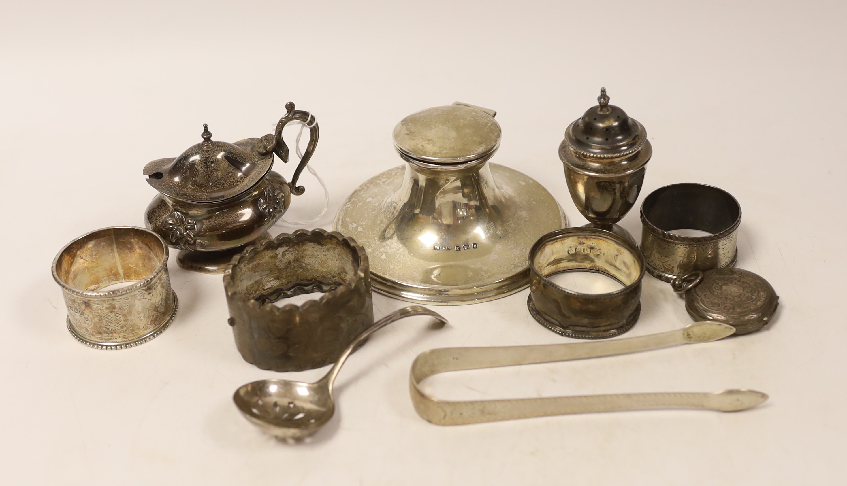 Sundry small silver including a capstan inkwell, napkin rings, condiments, fob watch and pair of Georgian sugar tongs.